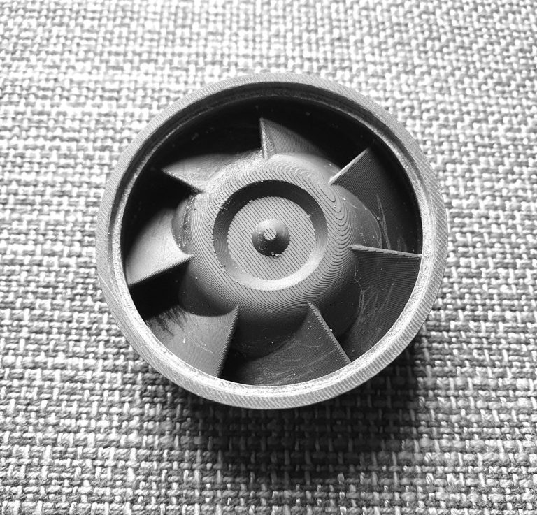 Impeller to swirl the air in a separation system for removal of fine dust